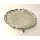 A modern silver salver with shaped border on scroll feet, maker 'P.B', diameter approx 26cm,