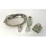 A silver mounted and glass pen and ink stand, three silver top bottles and an EP spring handled