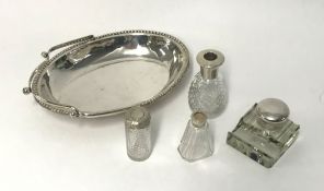 A silver mounted and glass pen and ink stand, three silver top bottles and an EP spring handled