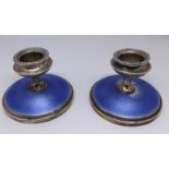 A pair of small silver and enamelled candlesticks, height 5.50cm.