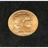France, a 1909 gold 20 francs.
