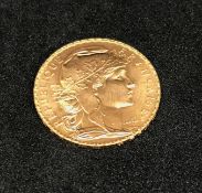 France, a 1909 gold 20 francs.