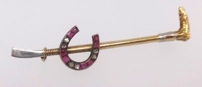 An early 20th century ruby and diamond set brooch modelled as a horseshoe and riding crop,