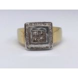 An 18ct square cluster dress ring set with four princess cut diamonds to the centre and with
