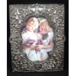A late Victorian silver photo frame by Walker & Hall, richly decorated, 20.50cm x 16cm.