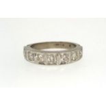 A white gold half hoop seven stone eternity ring, ring size P.