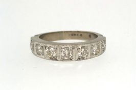 A white gold half hoop seven stone eternity ring, ring size P.