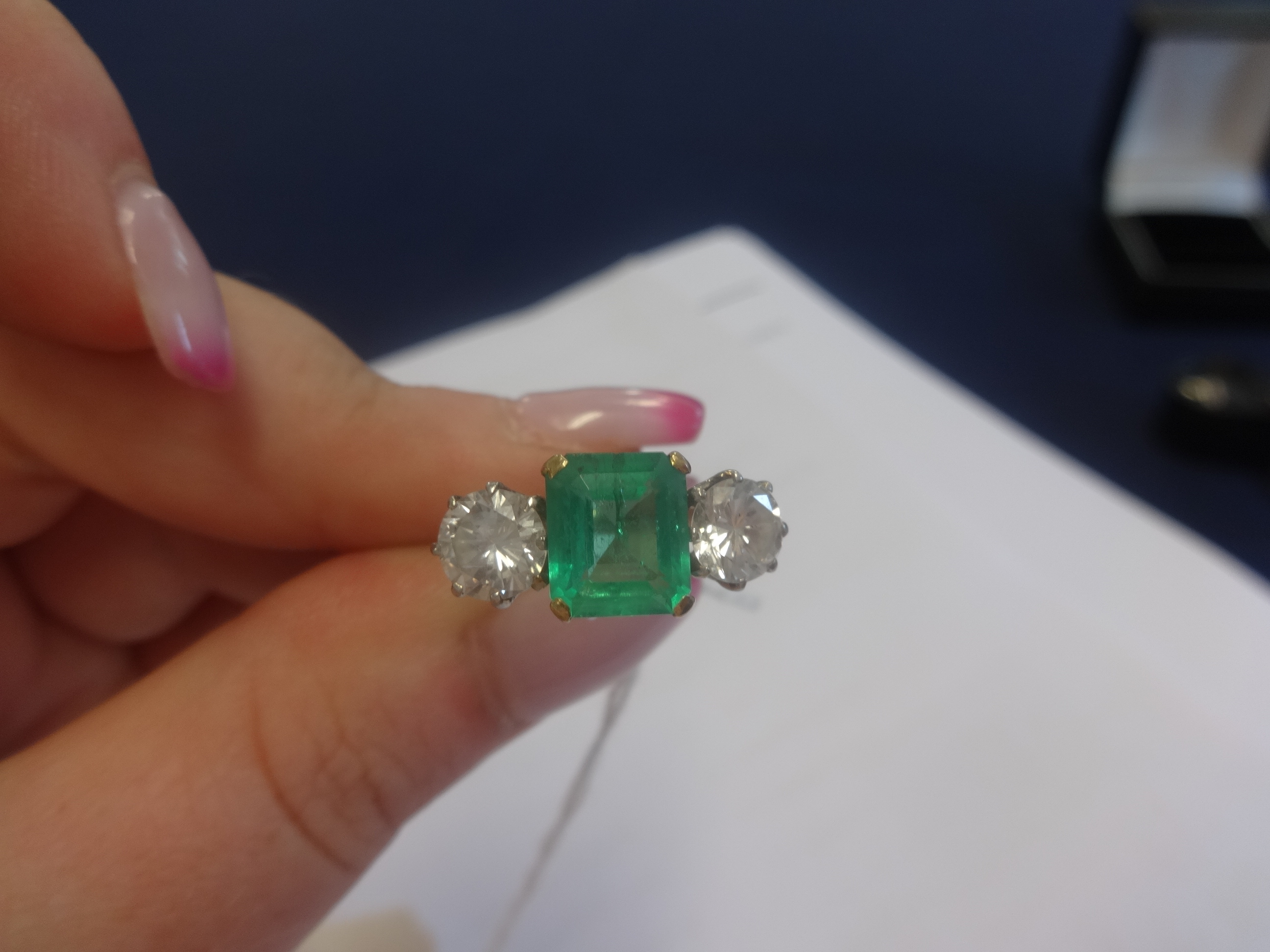 A platinum, emerald and diamond three stone ring, the centre stone measuring approx 9mm x 7mm, the - Image 2 of 5