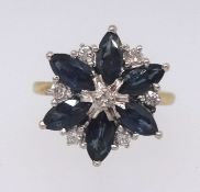 An 18ct sapphire and diamond flower style ring, ring size M.