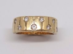 A half hoop ring with key hole motif head set with brilliant cut diamonds, unmarked, tested as