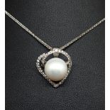 An 18ct open heart pendant and chain set with brilliant cut diamonds and a South Sea cultured