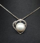 An 18ct open heart pendant and chain set with brilliant cut diamonds and a South Sea cultured