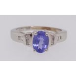 A tanzanite and diamond ring set in white gold stamped 14k,