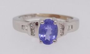 A tanzanite and diamond ring set in white gold stamped 14k,