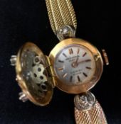 Universal, a pretty ladies 18ct gold and diamond set wristwatch, the dial with hinged flower and