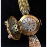 Universal, a pretty ladies 18ct gold and diamond set wristwatch, the dial with hinged flower and