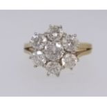 An 18ct diamond 'daisy' cluster ring set with an arrangement of seven bright diamonds, ring size O.