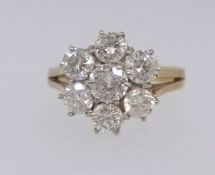 An 18ct diamond 'daisy' cluster ring set with an arrangement of seven bright diamonds, ring size O.