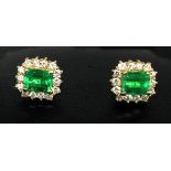 A pair of emerald and diamond cluster earrings in yellow gold with French wire fittings (matching