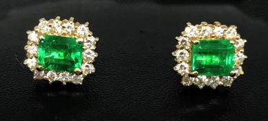 A pair of emerald and diamond cluster earrings in yellow gold with French wire fittings (matching