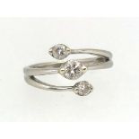 A modern diamond three stone ring, the centre round brilliant cut stone approx 0.30ct, two further