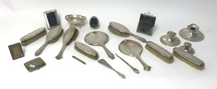 A mixed collection of various silverwares including three silver capstan inkwells, two dressing