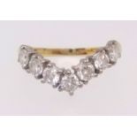 An 18ct diamond seven stone wishbone ring, ring size L.