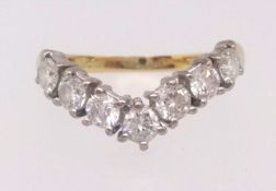 An 18ct diamond seven stone wishbone ring, ring size L.