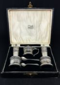 A Geo V five piece silver condiment set, cased.