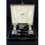 A Geo V five piece silver condiment set, cased.