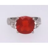 A Mexican fire opal ring set with nine further round cut diamonds in white gold, stamped