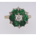 An 18ct emerald and diamond cluster ring, ring size K.