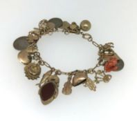 A 9ct gold mixed charm bracelet, approx 40.3gms.