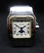 Cartier, Santos, a ladies gold and stainless steel wristwatch, with moon phase & date, the square