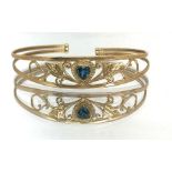 A 9ct gold bangle set with heart shaped blue stone, approx 6.60gms.