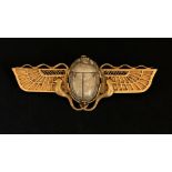 An antique gold Egyptian Revival brooch set with a carved hardstone scarab indistinctly marked,