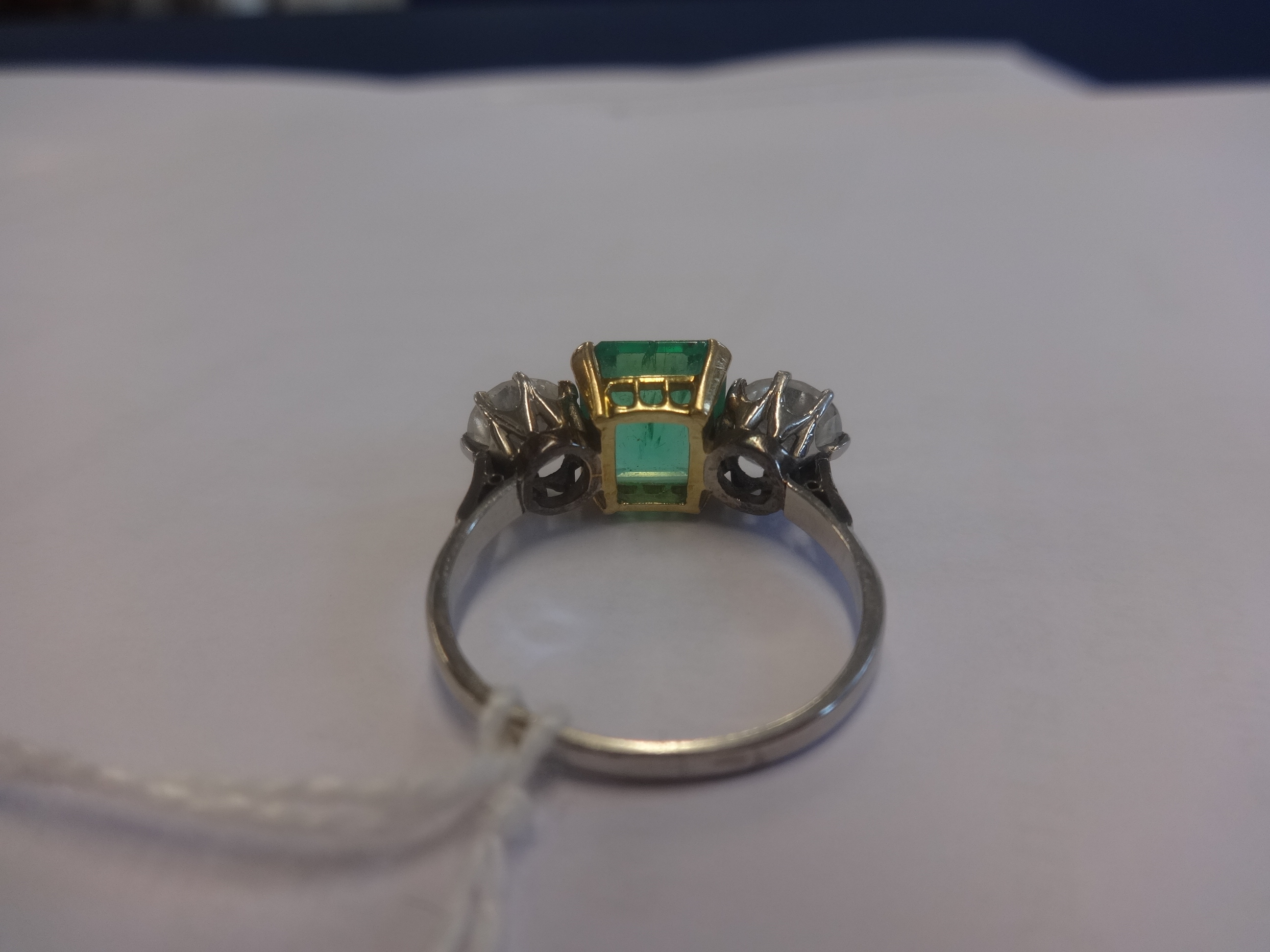 A platinum, emerald and diamond three stone ring, the centre stone measuring approx 9mm x 7mm, the - Image 3 of 5