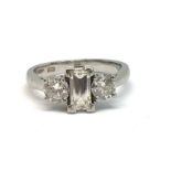 A good modern platinum three stone diamond ring, with a centre step cut diamond, weighing approx 0.