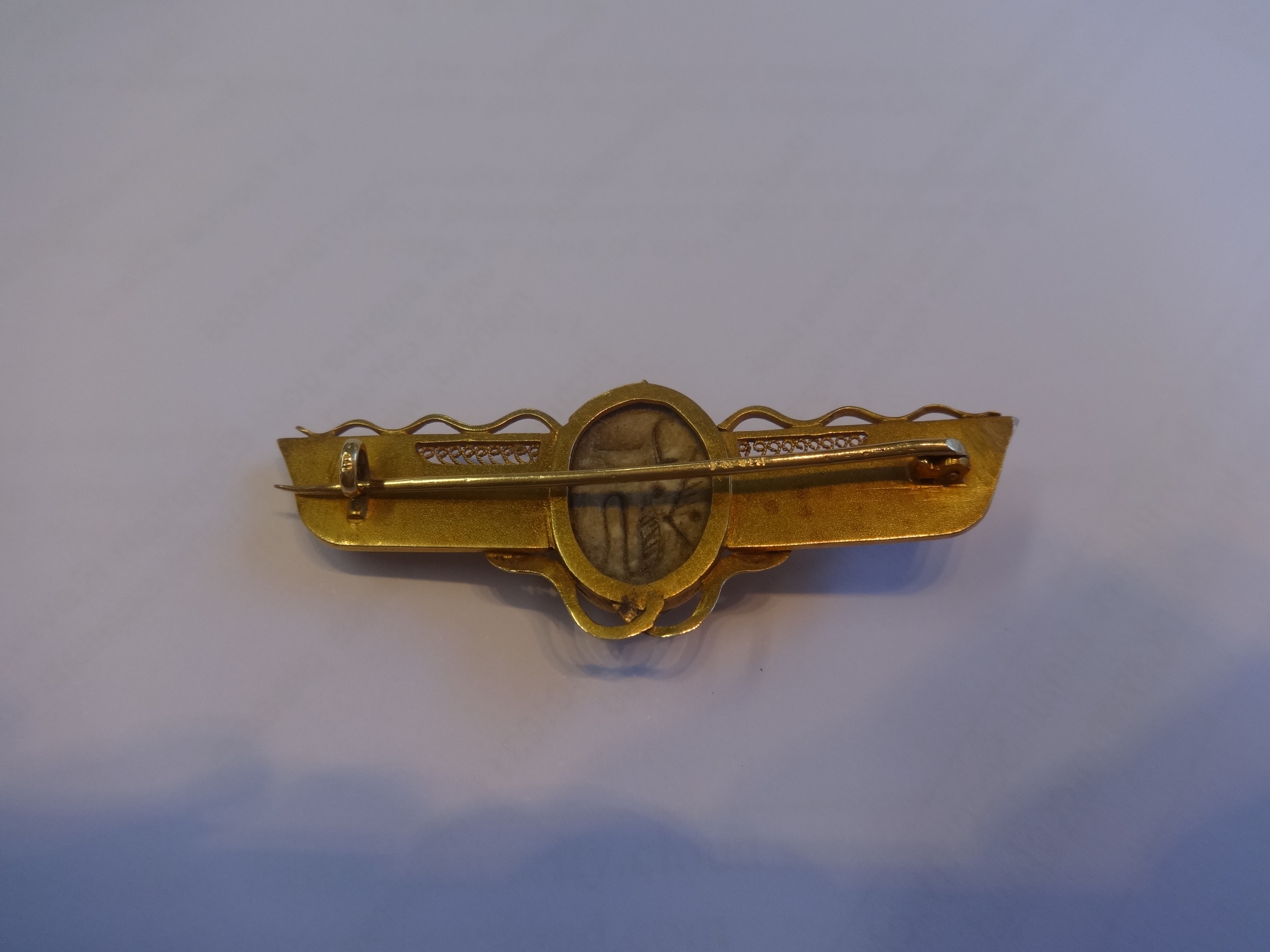 An antique gold Egyptian Revival brooch set with a carved hardstone scarab indistinctly marked, - Image 2 of 2