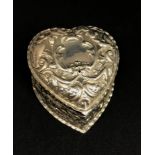 A Victorian silver heart shaped box with embossed decoration depicting birds and foliage, approx