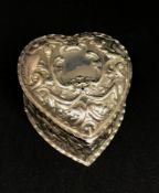 A Victorian silver heart shaped box with embossed decoration depicting birds and foliage, approx