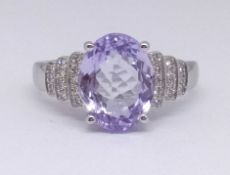 A 14k white gold tanzanite and diamond ring set with an oval cut tanzanite approx 3.15ct, diamonds