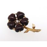 A dark ruby style and diamond set brooch, of flower design set in yellow metal, length approx