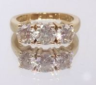 A good 18ct yellow gold diamond three stone ring, ring size M.
