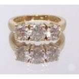 A good 18ct yellow gold diamond three stone ring, ring size M.