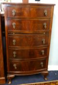 A reproduction bow fronted chest fitted with five drawers and a brushing slide together with a