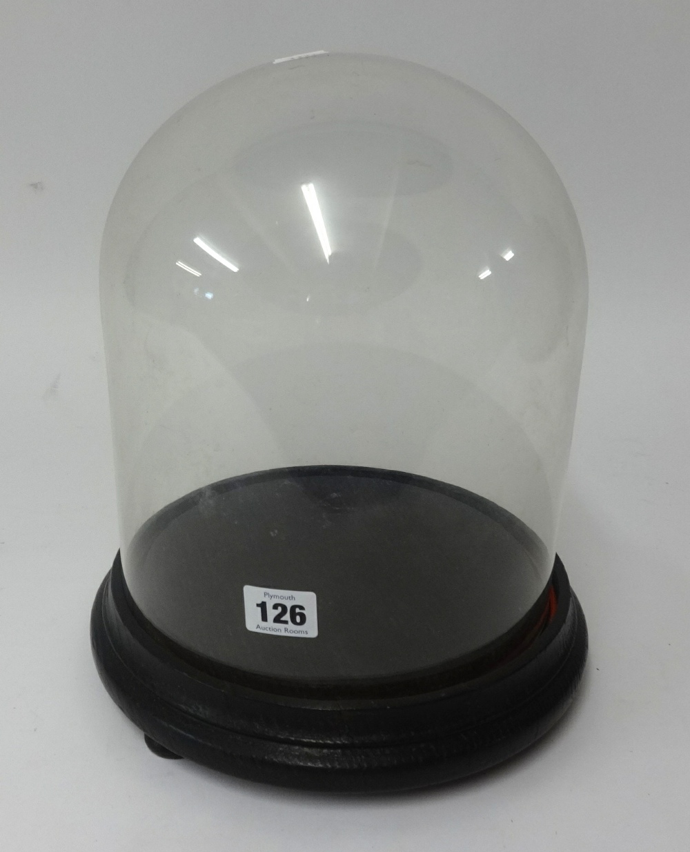 A glass dome and base, height 22cm.