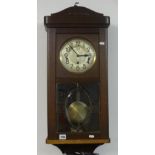 An oak cased wall clock circa 1920, together with a oval barbola wall mirror (2).