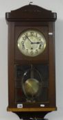 An oak cased wall clock circa 1920, together with a oval barbola wall mirror (2).