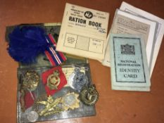 Various military cap badges including 'Manchester', 'RAF' etc, WWII ration and ID books of G.Gamin
